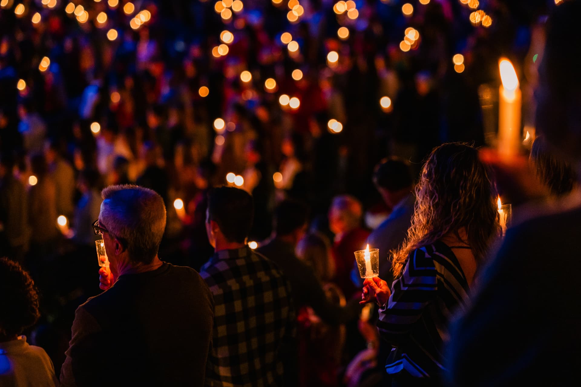 Christmas candlelight beneath festive lights