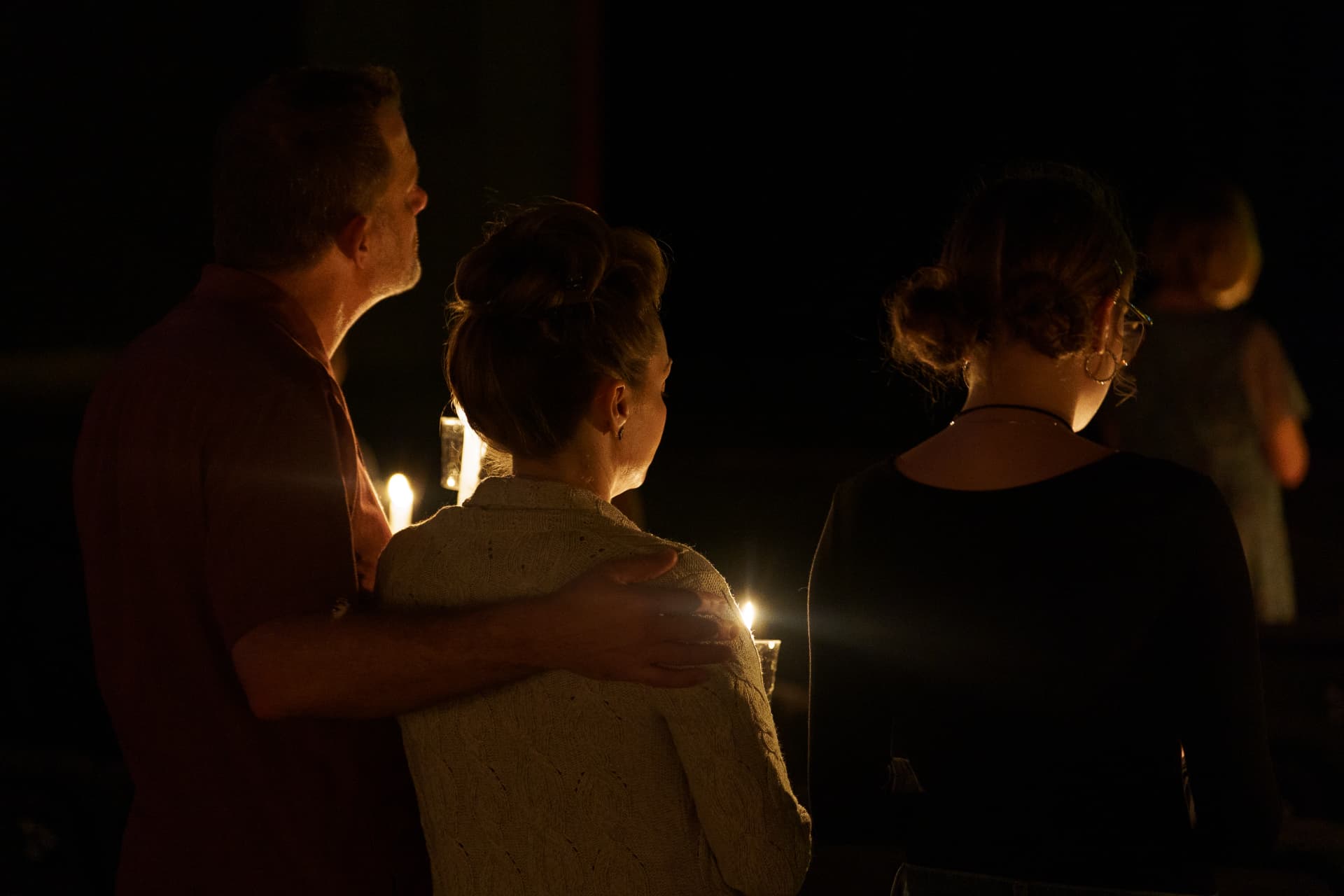 A family sharing a candlelight moment