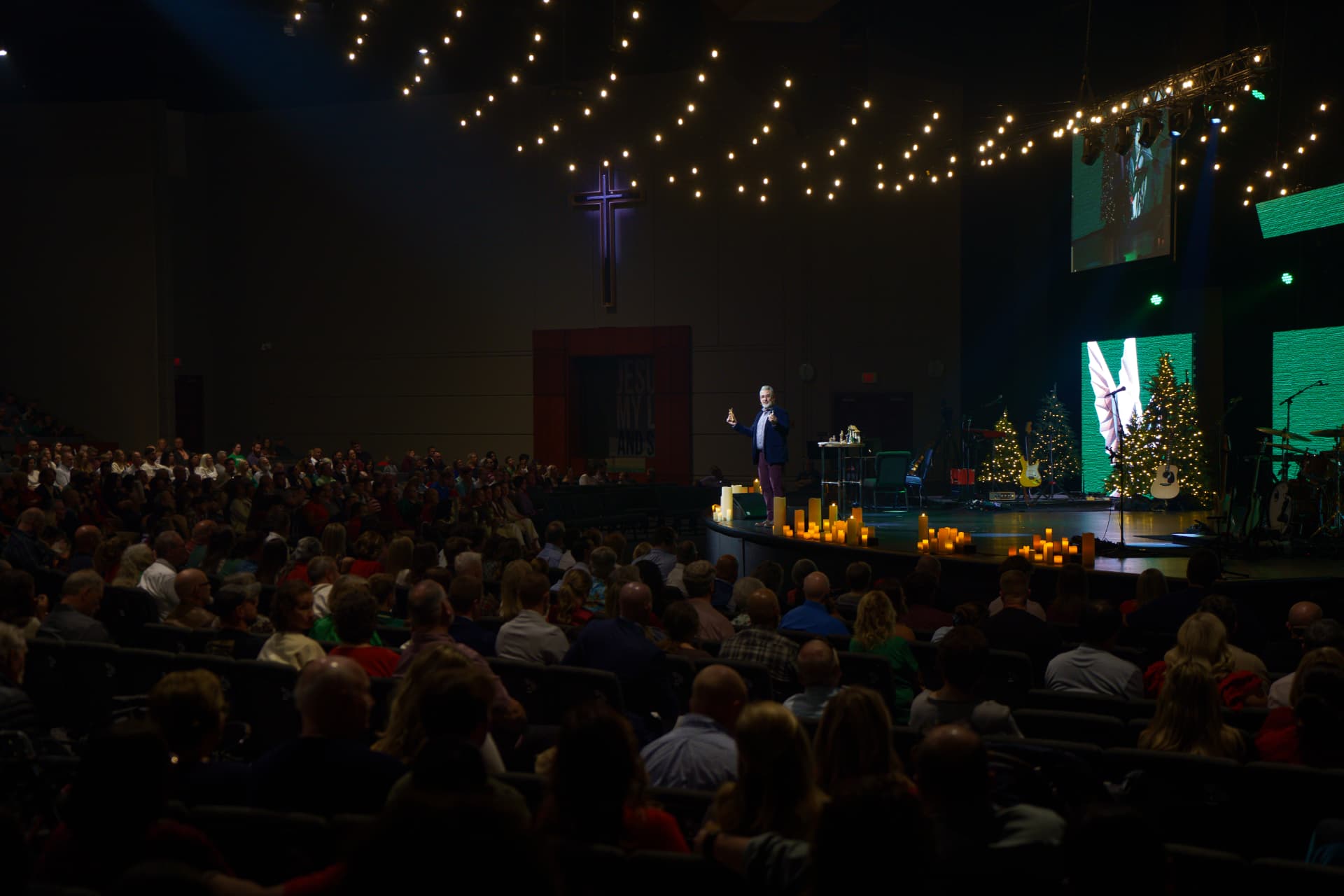 Christmas service beneath strings of warm lights